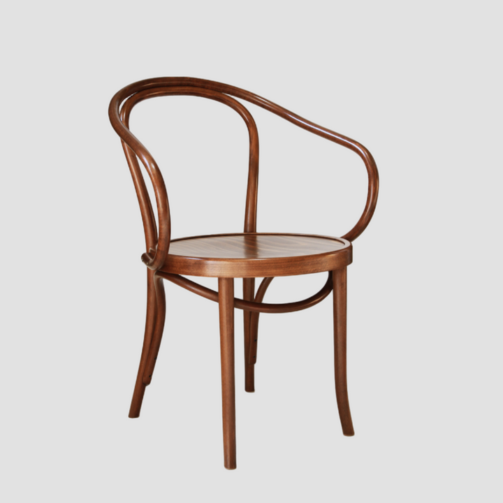 Wooden chair in a walnut stain with curved backrest on a light grey background