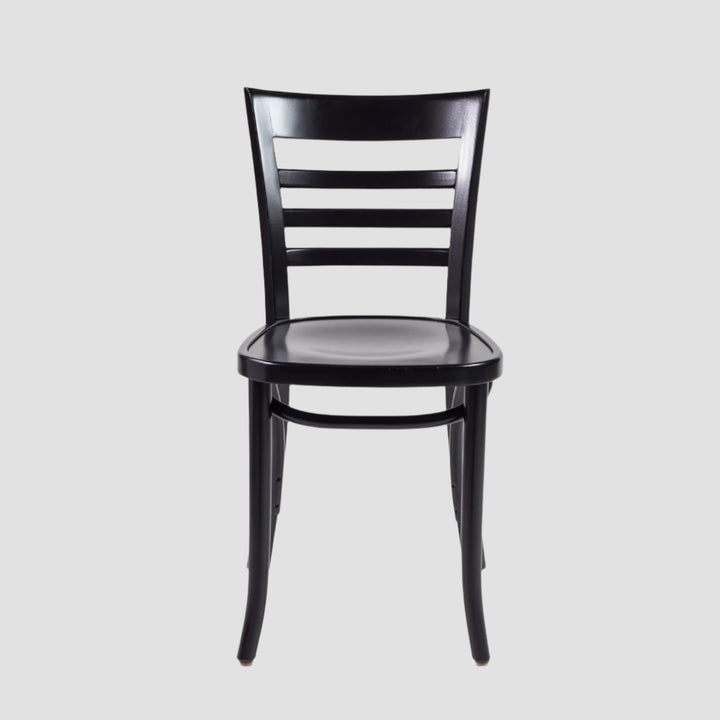 Front view of a black wooden chair with slatted backrest