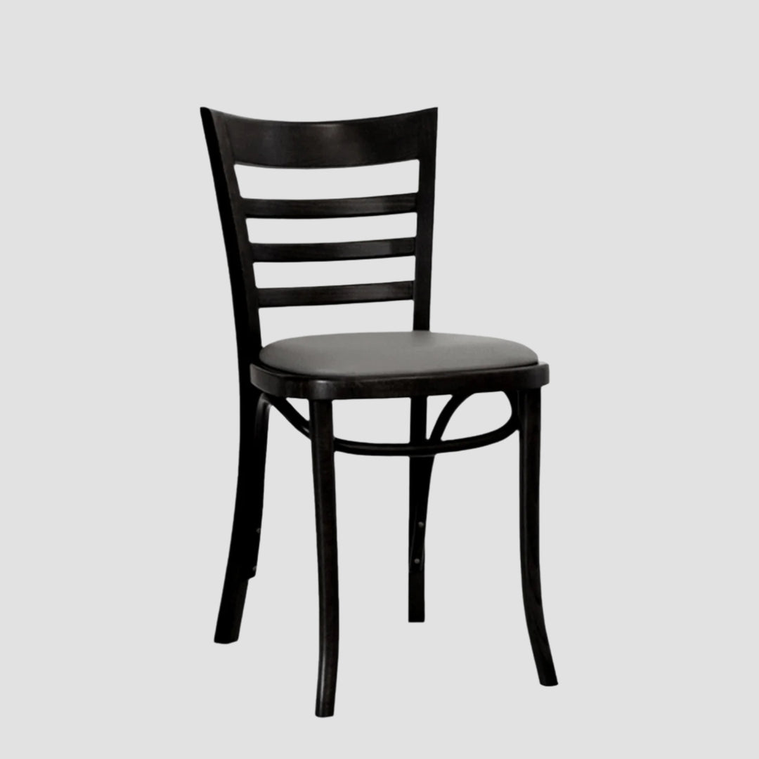 Front angle view of a black wooden chair with slatted back and a grey leather seat pad