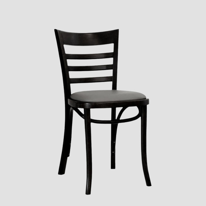 Front angle view of a black wooden chair with slatted back and a grey leather seat pad